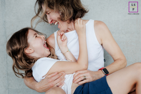A mother and daughter sharing a joyful portrait session in Paris, beaming with happiness and love.
