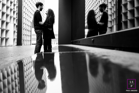 In Esch-sur-Alzette, Luxembourg, a lifestyle couple portrait captures a quiet scene filled with reflections. The black and white quad reflection shot highlights repeating patterns, emphasizing their serene connection and the artistic composition.