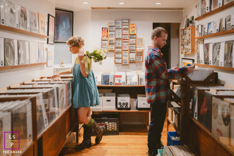 In East Village, New York, a couple strolls through a record shop. The scene captures their shared love for music and the vibrant urban atmosphere of this iconic neighborhood.