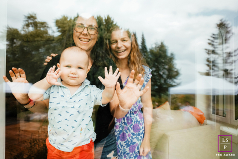 Family Gathered in Festive Unity by the Glass Window in Carp, Ontario, Canada In Carp, Ontario, Canada, family members gather in front of a glass window during a festive family party.
