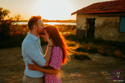 In Mauguio, France, a couple enjoys a portrait session at sunset, surrounded by soft, evening light.