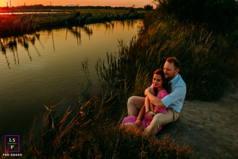 In Mauguio, France, a couple’s session unfolds at sunset, backlit by golden, warm-toned light.