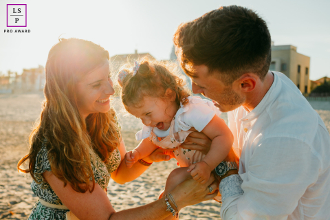 At Carnon Plage in France, a family plays together on the beach, enjoying the seaside atmosphere.