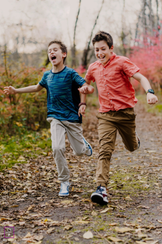 In Bergen County, New Jersey, brothers race each other, both caught mid-air as they run with exuberant energy.