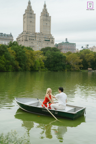 In New York, a couple drifts in a rowboat on Central Park’s waters, sharing a tranquil session together.