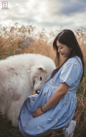 A quiet, tender moment between mother and pet dog before the baby's arrival.