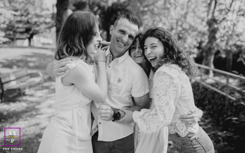 Father, Mother, and two daughters, arms linked, share a deep, loving bond in a candid portrait, symbolizing special family ties.
