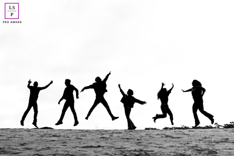 A vibrant lifestyle portrait in Hilversum, Netherlands, capturing a moment of creative inspiration illuminated by harsh, strong sunlight.