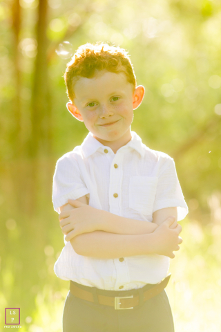 Confident young boy with arms crossed posing for a portrait in Reno, Nevada.