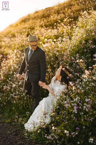 Bathed in golden light at Coyote Hills, the couple moves through wildflowers with the tenderness of two people quietly choosing each other again. The flowing hillside, warm tones, and gentle handhold give the photo a timeless, almost cinematic romance.