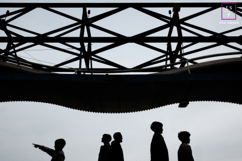 Paris Family Walks in Silhouette Beneath Striking Modern Canopy in a Graphic Minimalist Portrait This Paris family appears in silhouette beneath a striking geometric canopy, each figure separated by posture and gesture. The child pointing adds curiosity and direction, while the minimalist composition transforms an ordinary walk into something graphic