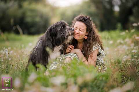Lyon, France: Owner sits beside dog receiving a gentle kiss on the cheek.