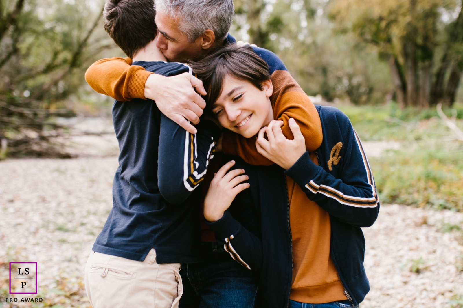 Bourgogne-Franche-Comte dad holding his boys, showing love to them in this family photo session 