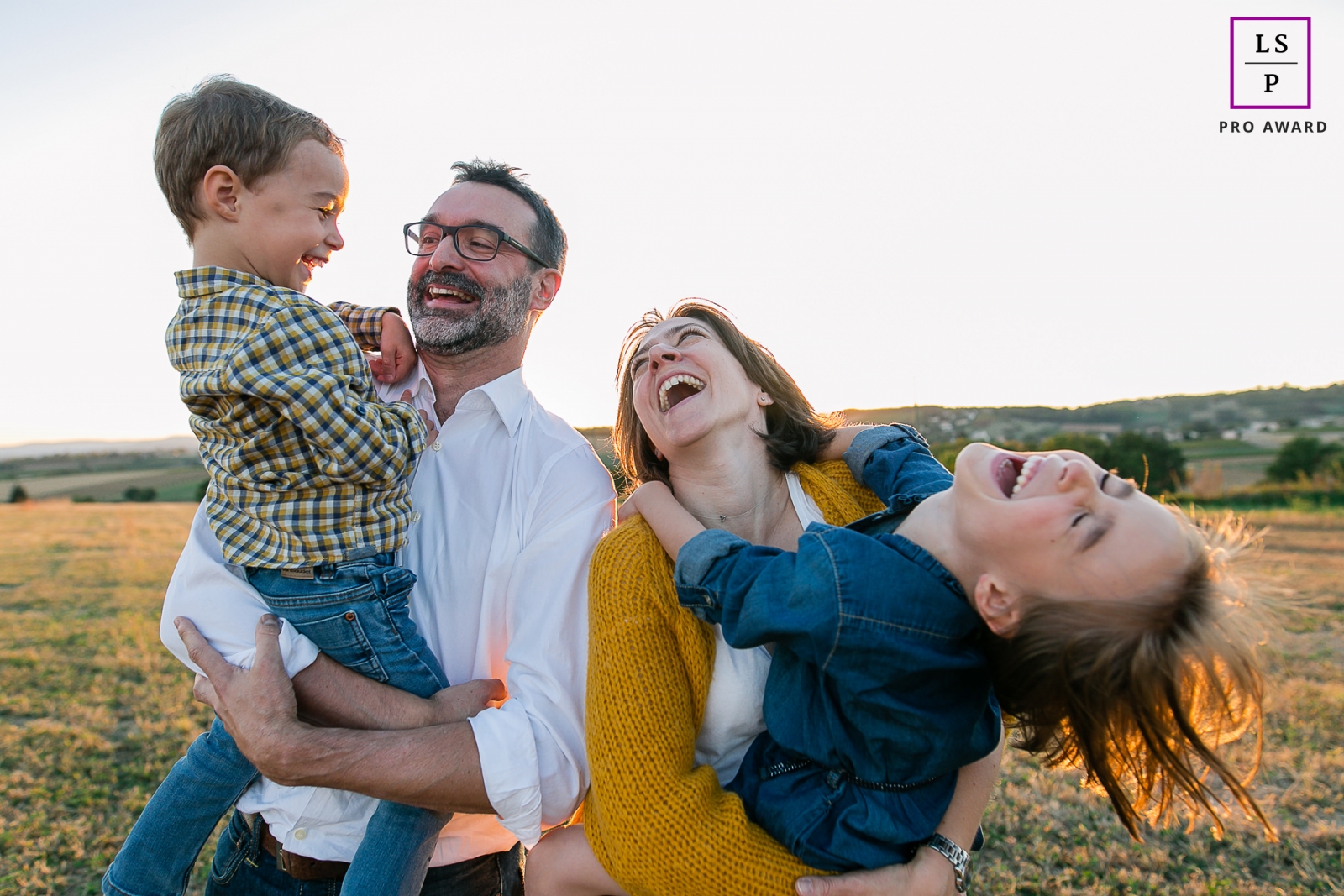 France Afternoon Lifestyle Portrait Photography in Bourgogne-Franche-Comte | Image contains: color, sunset, family, holding, hug, posing ideas, shot