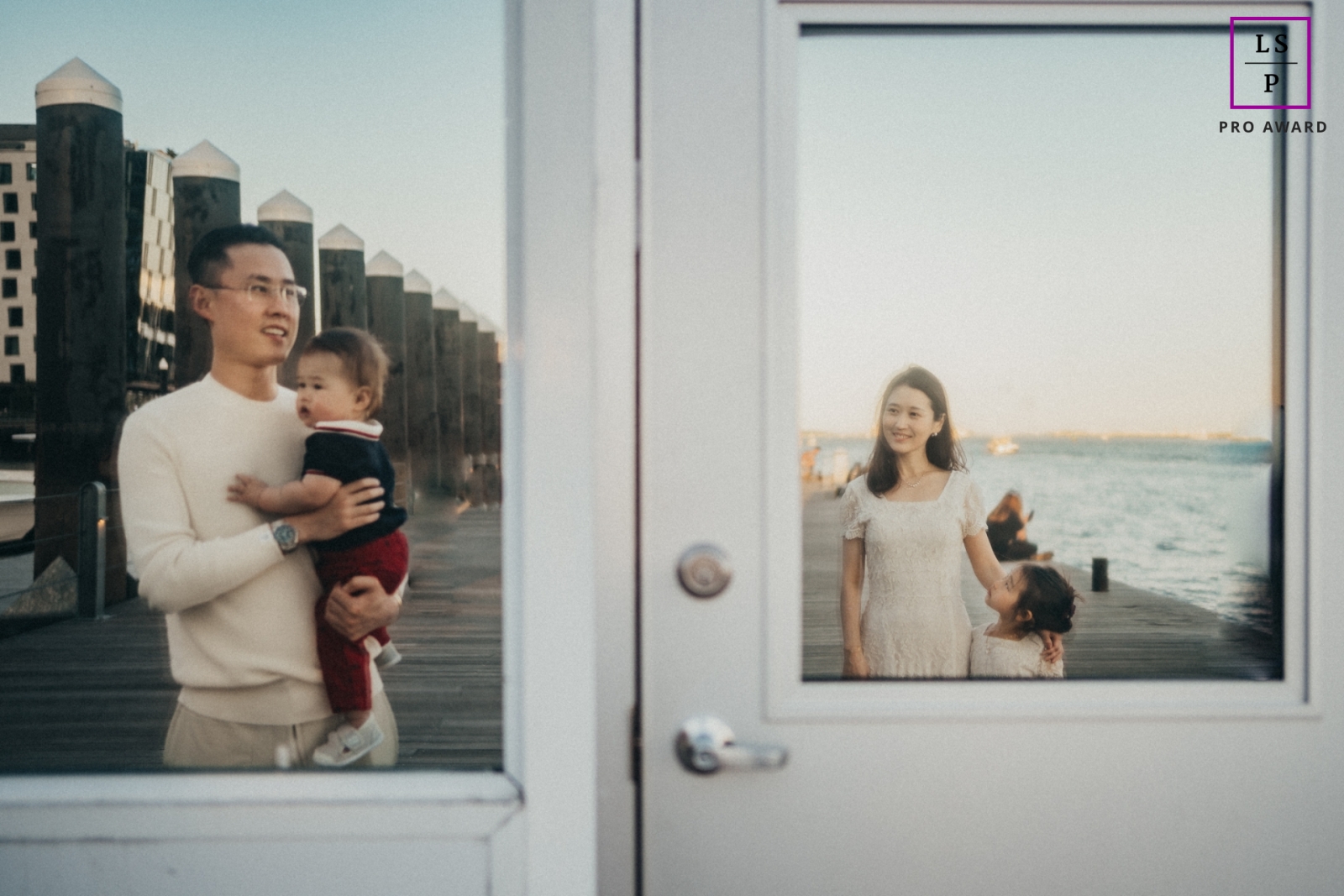 A modern New York lifestyle photography session that documented a family on a pier with glass reflections