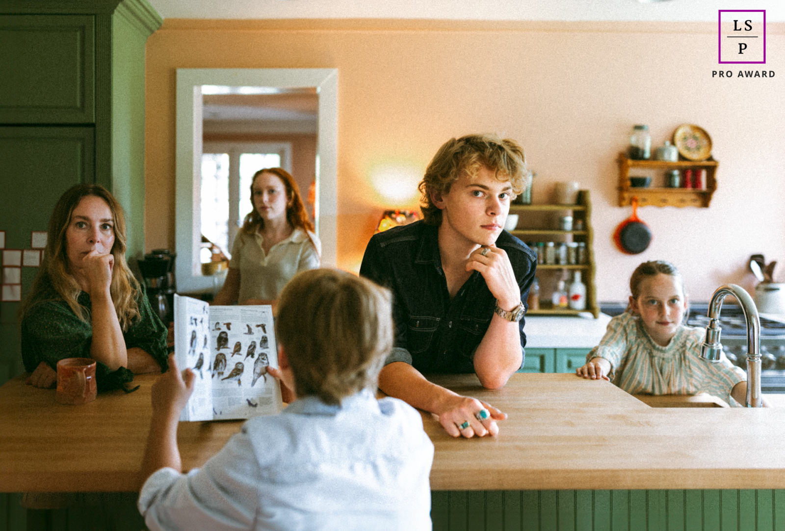 A homeschool family poses in their Nashville kitchen, captivating your attention with intriguing expressions and drawing you into the frame to study their faces.