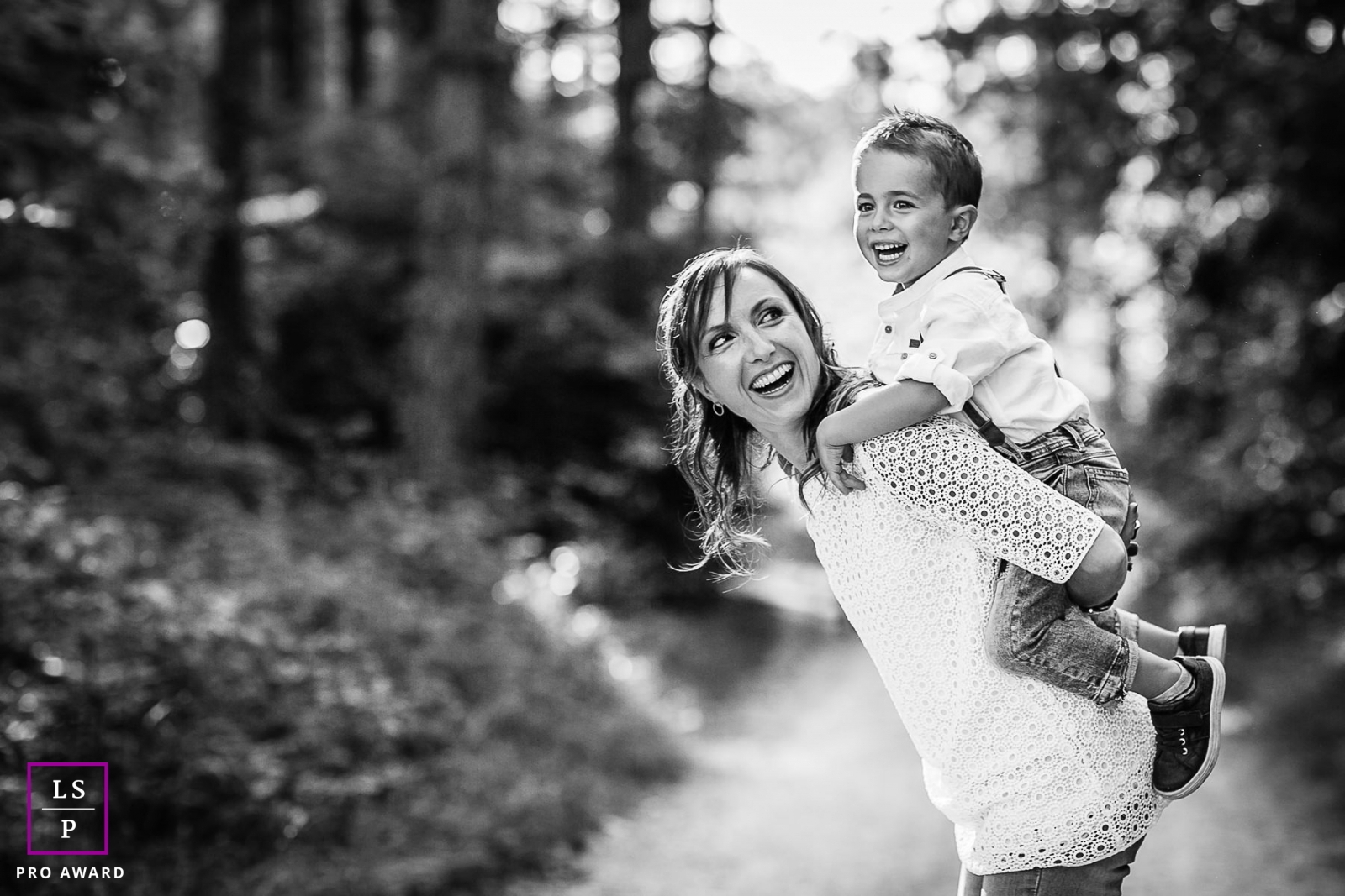 Bourgogne-Franche-Comte Family Lifestyle Photography with Mom and Son | Image contains: boy, mother, black, white, outdoors, piggyback ride, smiling, tips