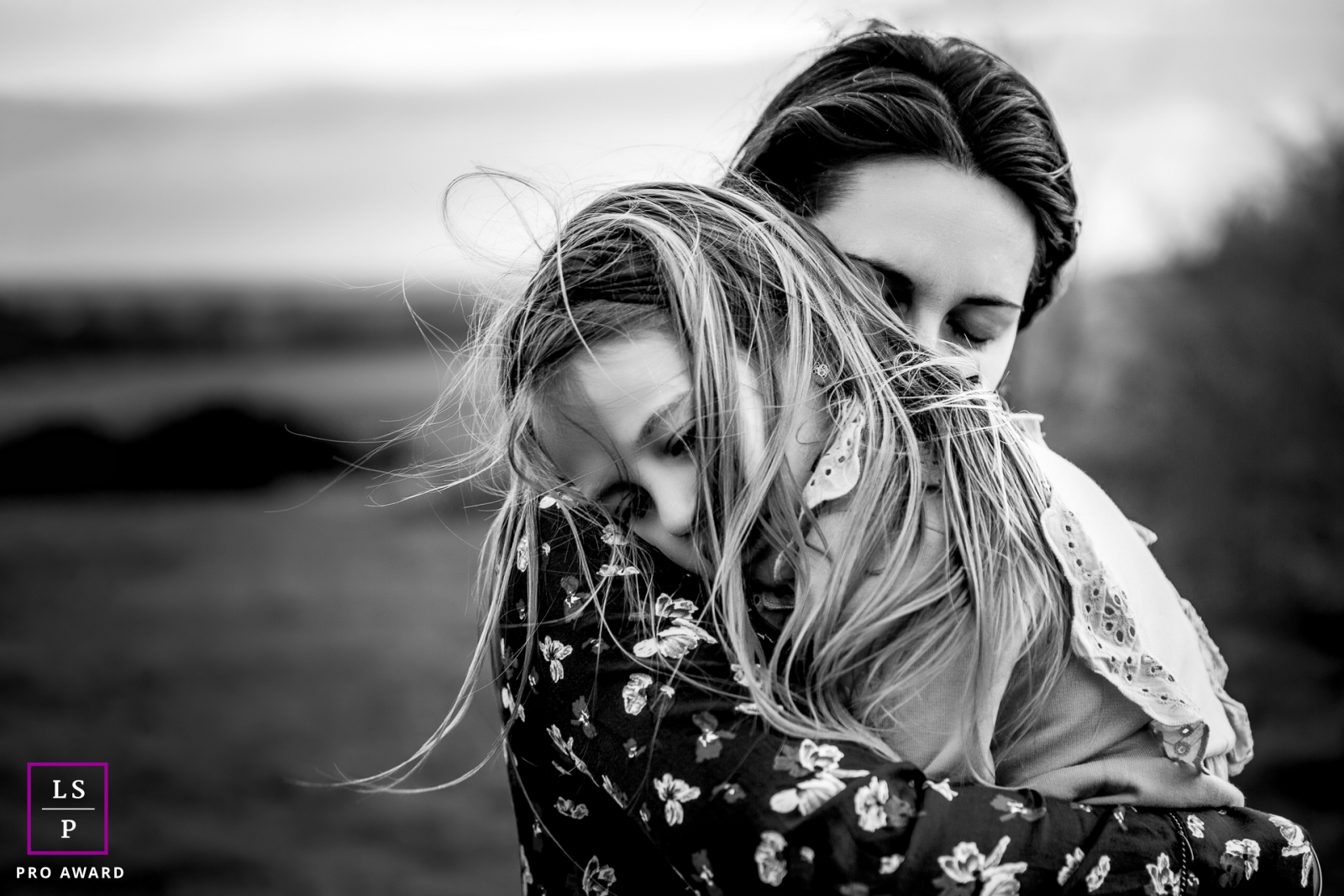Auvergne-Rhone-Alpes mom and daughter hug in the winter wind