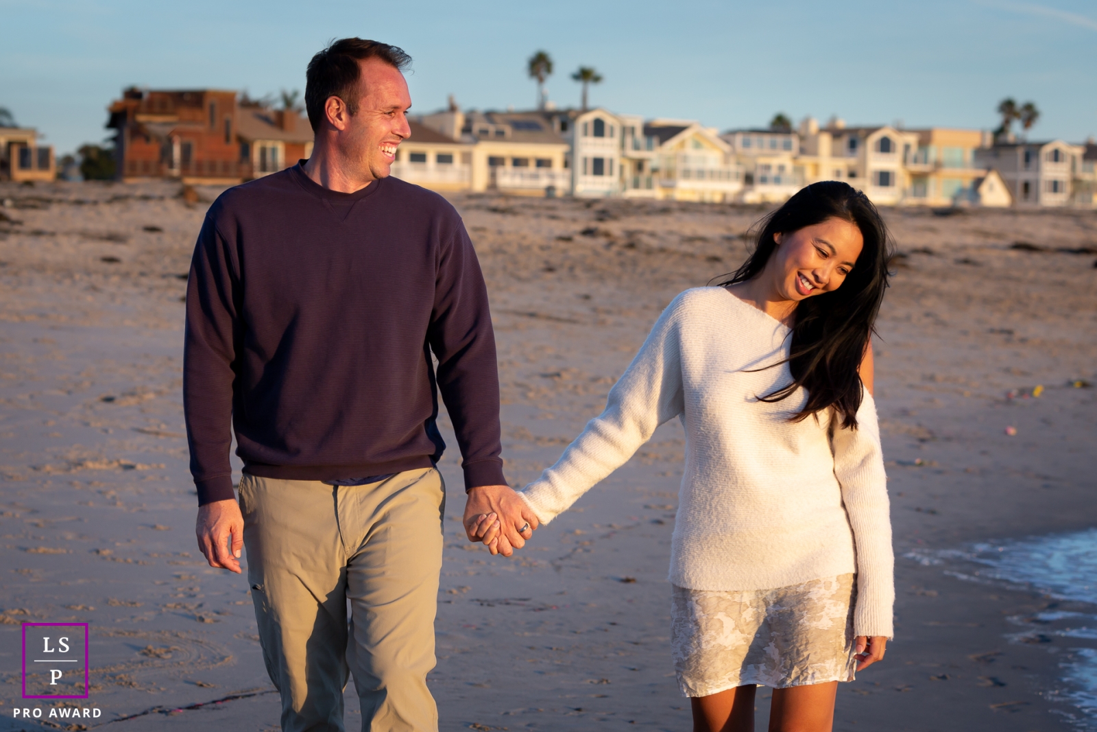 California couple Lifestyle image with some walking and laughing together on the beach