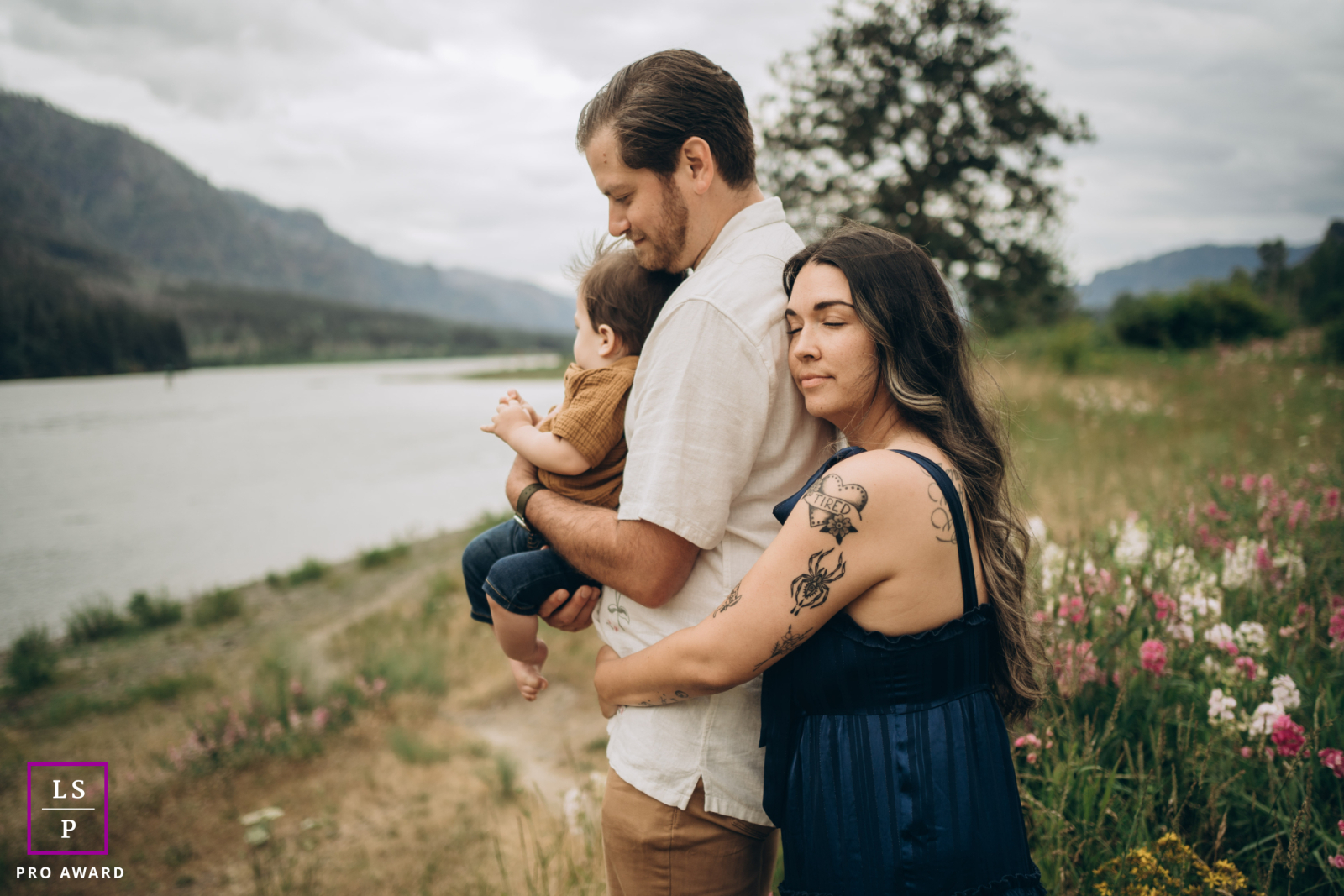 In Washington, USA, a beautiful family stands together by the river at the gorge, enjoying the scenic landscape.