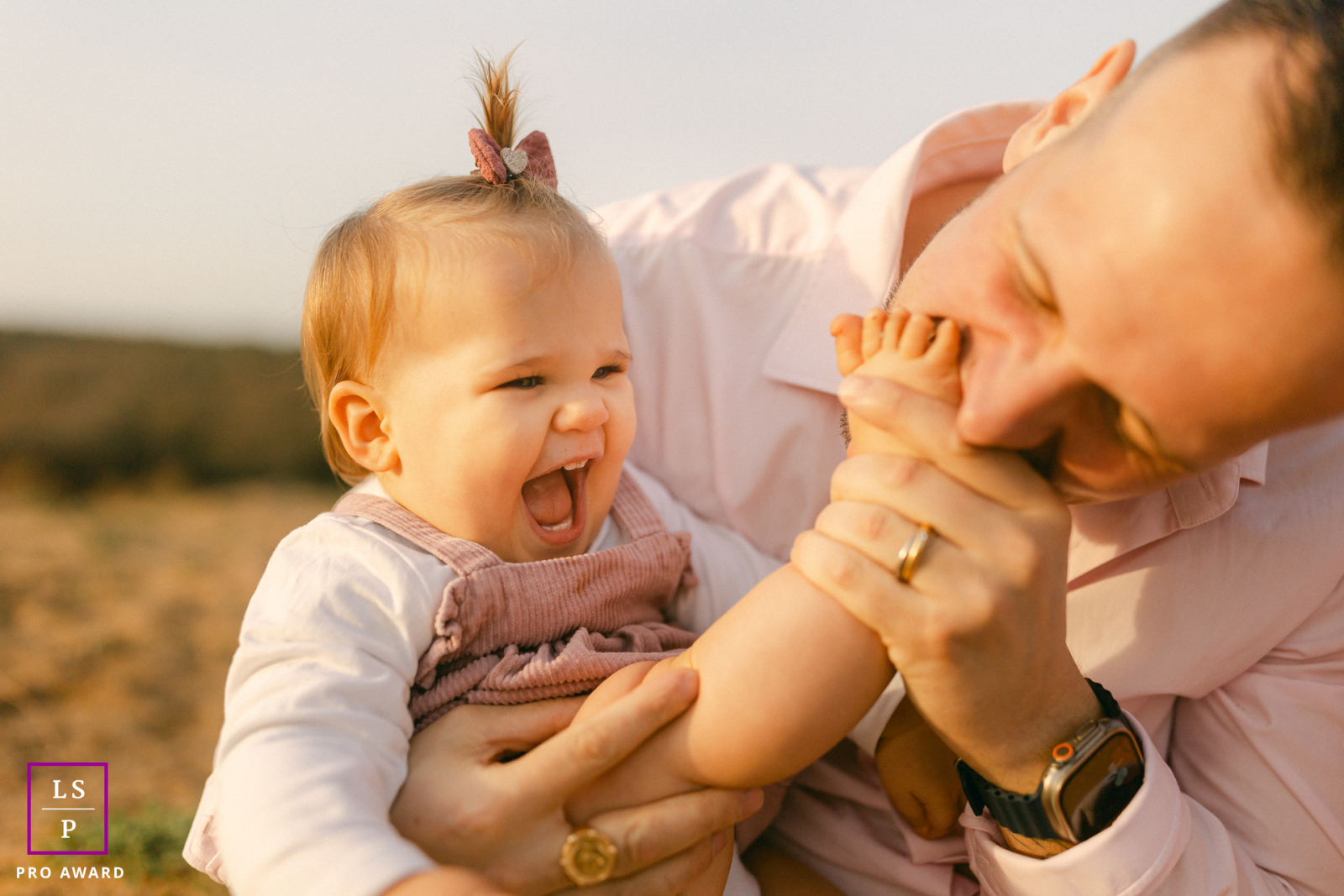 During sunset in Vendée, this playful exchange between father and child erupts into laughter and movement. The warm beach light and tight framing keep the photograph focused entirely on joy, connection, and wonderfully spontaneous family energy.
