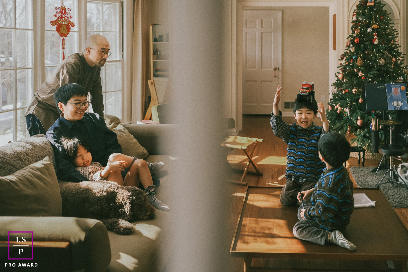Seen through the divided doorway in this New Jersey home, the family unfolds in two simultaneous scenes of play and quiet rest. The layered framing and warm holiday light give the photograph depth, intimacy, and beautifully observed everyday storytelling.