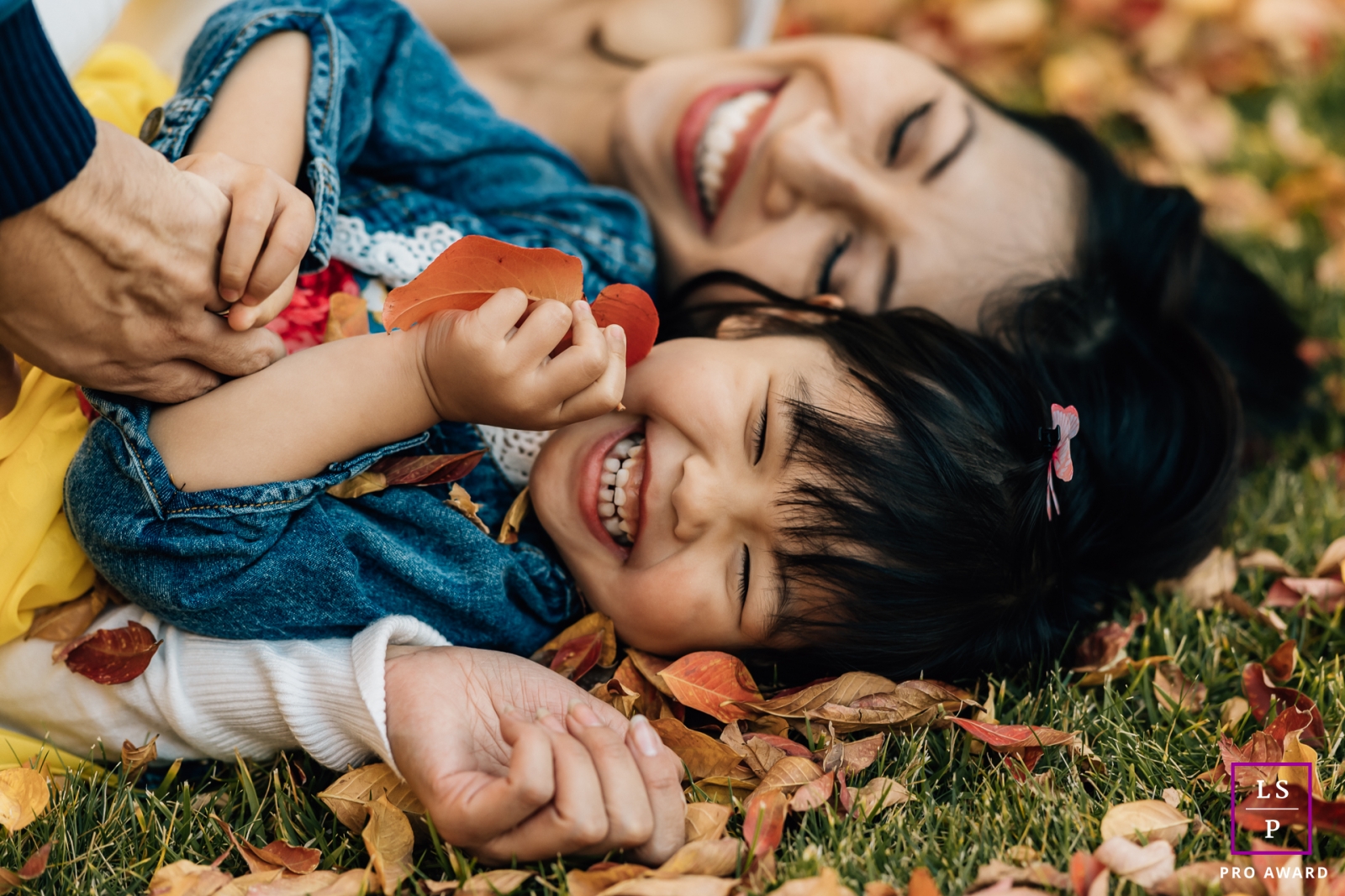 Oakland girl playing with mommy in the leaves during this California portrait session
