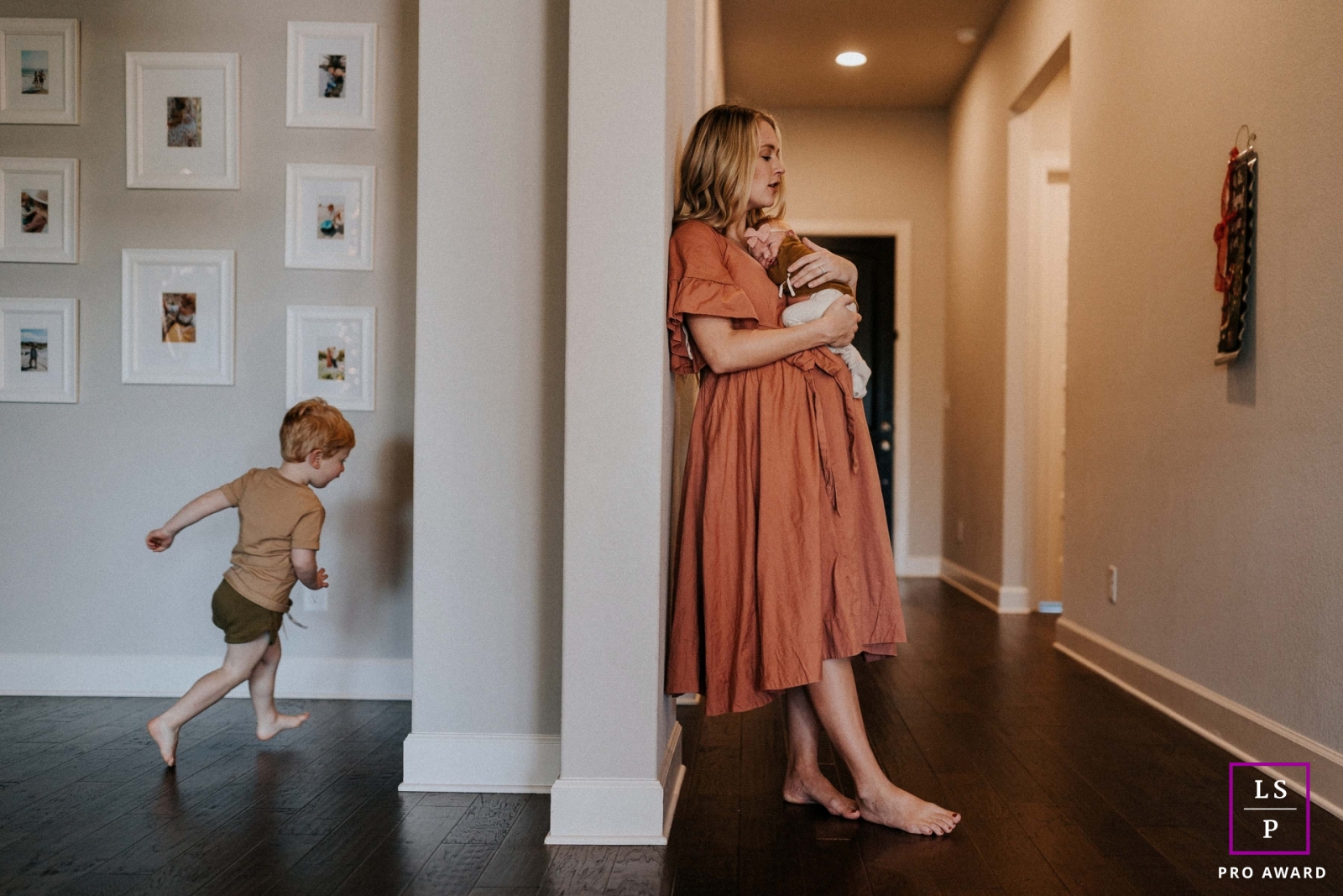 Tennessee Lifestyle Photographer created this artistic portrait of a mother with her newborn and young son running in their home session