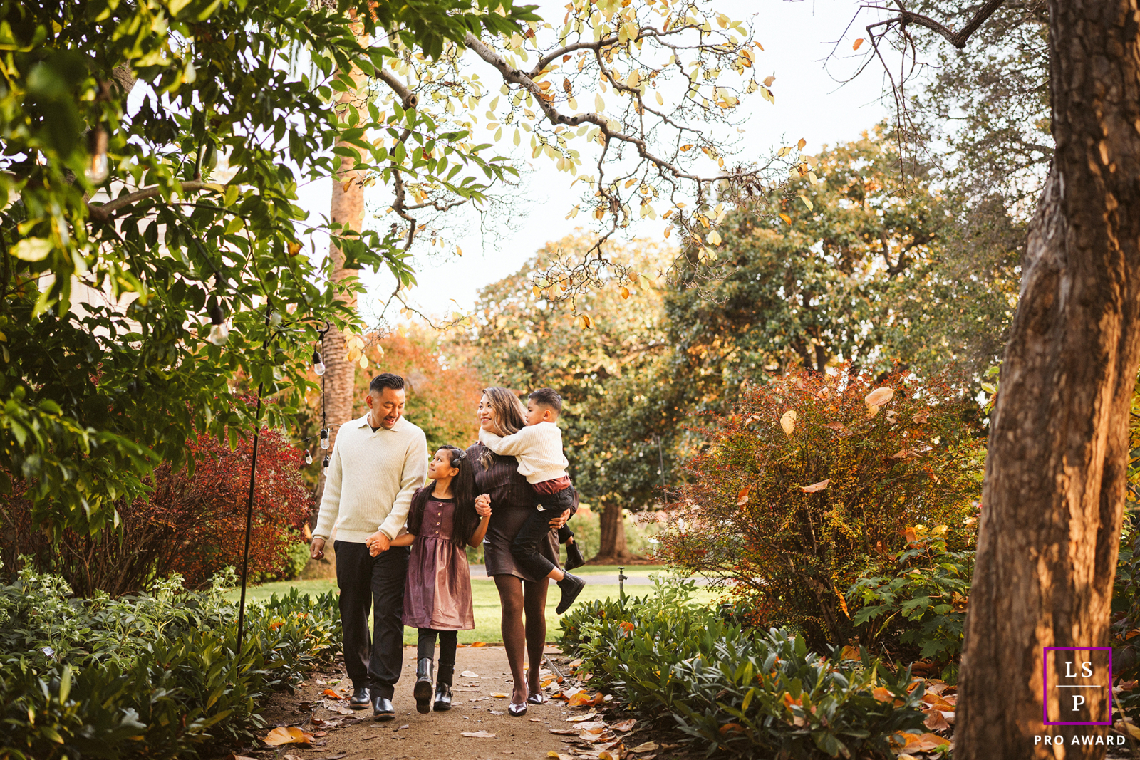 Surrounded by autumn color at Elizabeth F. Gamble Garden, this family strolls the winding path with the relaxed rhythm of an ordinary afternoon made memorable.