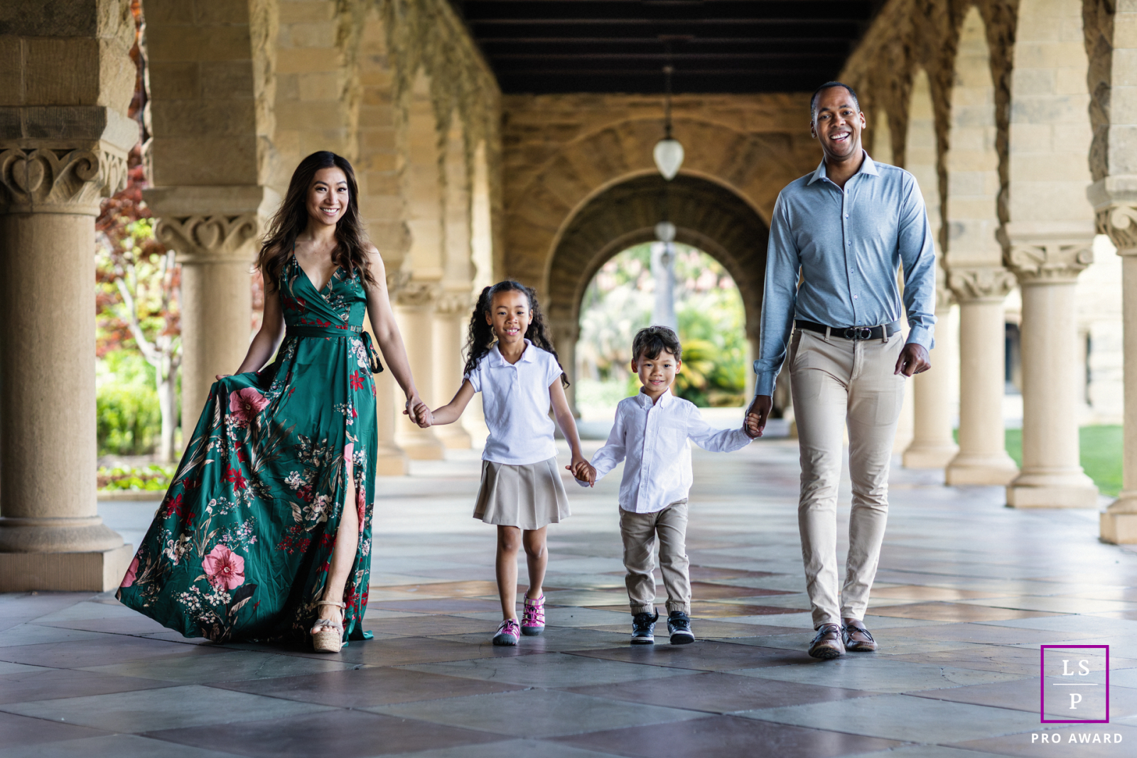Walking beneath the grand arches in Palo Alto, this family moves together with the rhythm of a small parade, each stride filled with confidence and connection. The repeating columns and balanced composition shows elegance without losing its warmth.