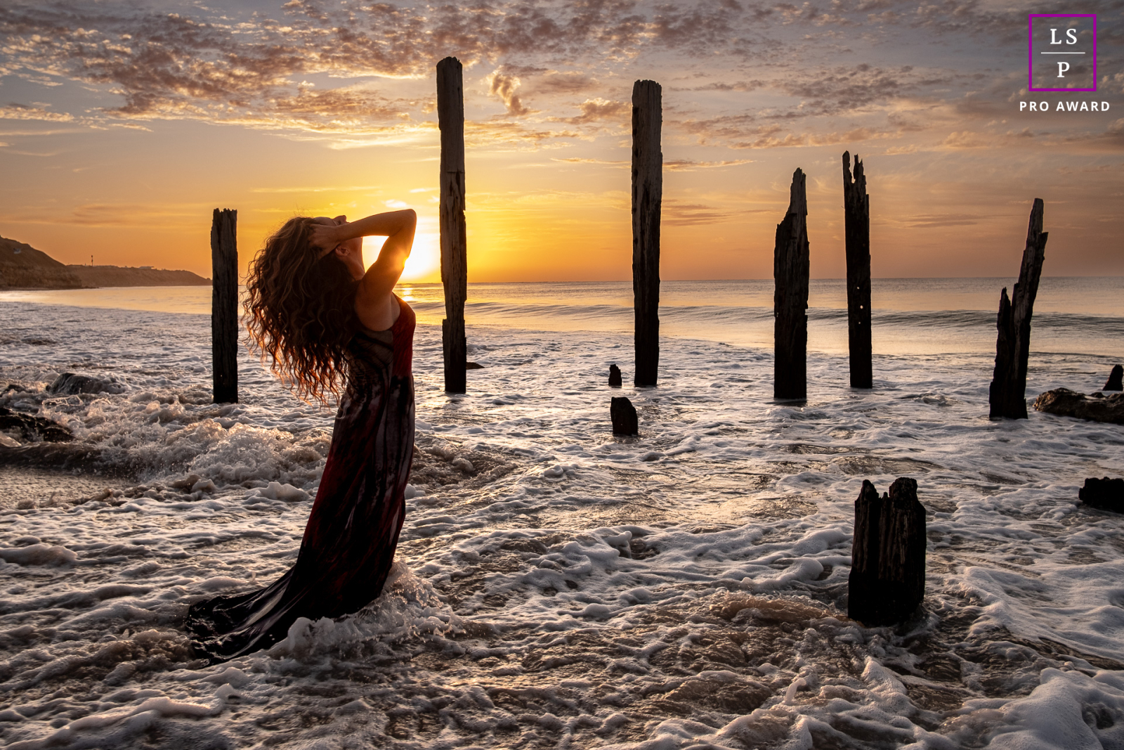 A stunning amalgamation of nature and human form, this lifestyle portrait captures a woman in complete harmony with her surroundings. Against the breathtaking backdrop of Port Willunga, South Australia, she stands alone at the pier pilon ruins.