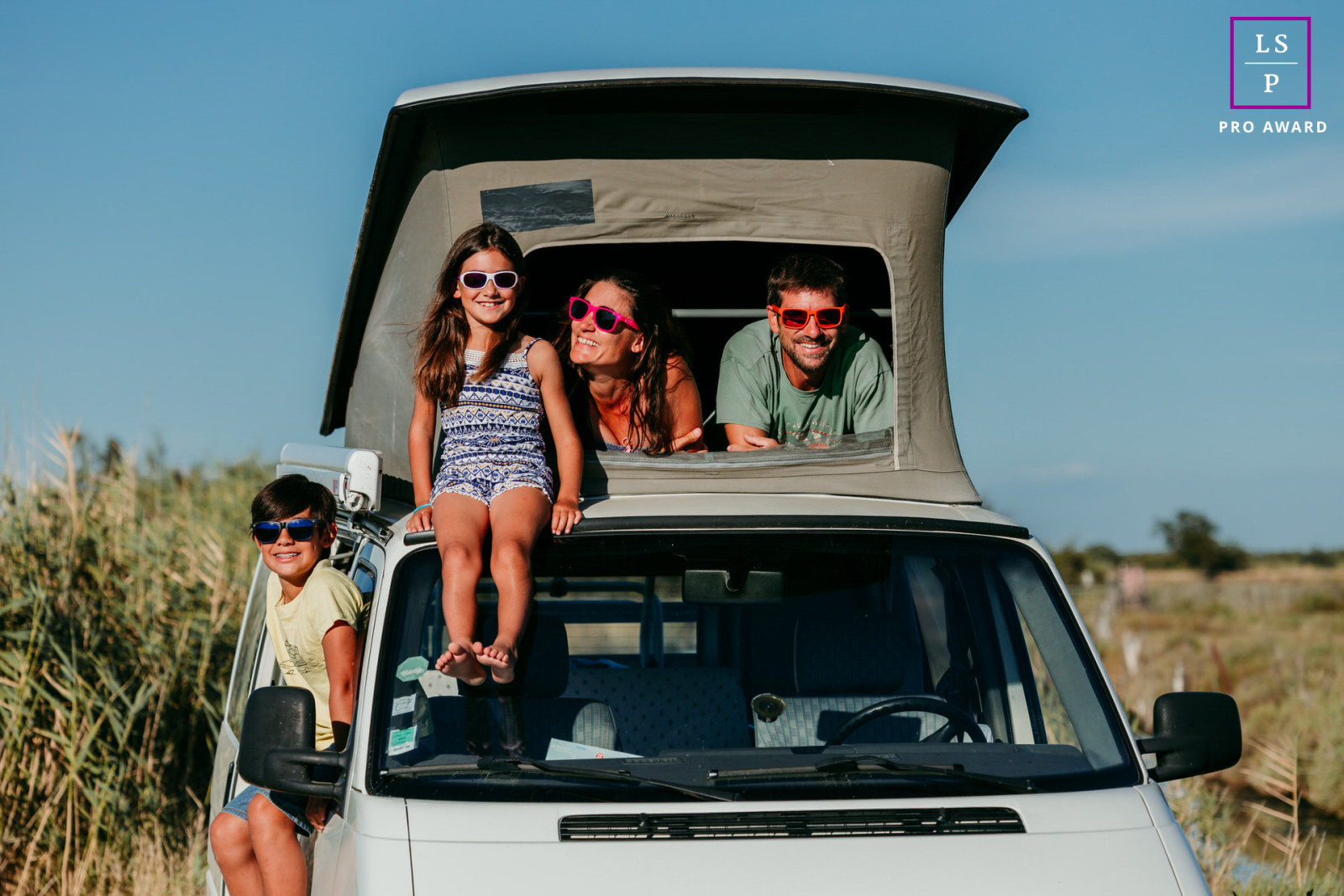 In Mauguio, a family enjoys a travel adventure in their pop-up camper van, capturing the spirit of exploration and togetherness on their journey.