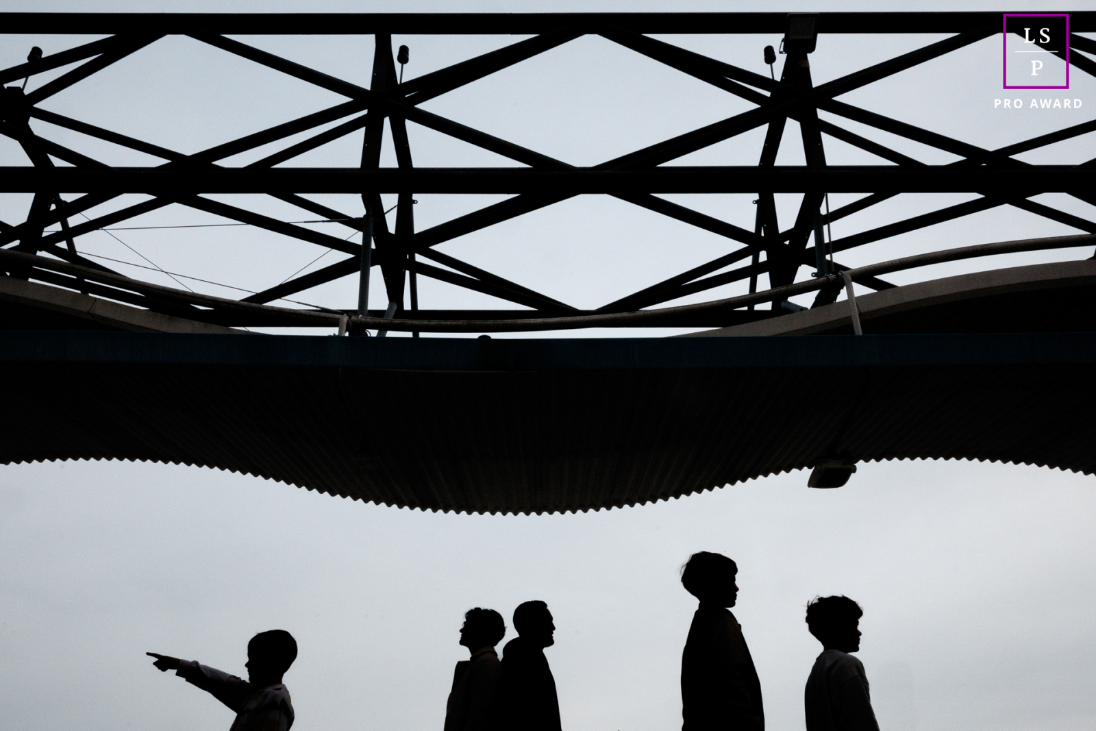 This Paris family appears in silhouette beneath a striking geometric canopy, each figure separated by posture and gesture. The child pointing adds curiosity and direction, while the minimalist composition transforms an ordinary walk into something graphic