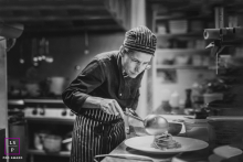 Black and white portrait of Chef Nicoletta in the kitchen of Ristorante il Mestolo, Siena, Tuscany, Italy. Capturing her focus and passion as she works, this image highlights the artistry of culinary craftsmanship.