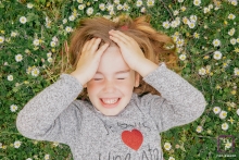 Cote-d'Or girl poses for a lifestyle photoshoot laying on the ground with flowers