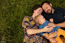 lifestyle family photo from an overhead view of a hug in the grass Creative Doubs lifestyle family photography with an overhead view of a Hug in the grass