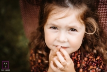 A pro Ain lifestyle solo photo showing a portrait of a shy little girl