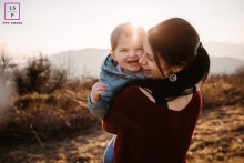 Lifestyle family photography from Ain showing a hug with mom 