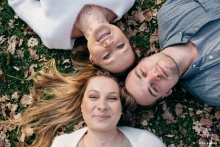 Dijon creative lifestyle family portrait of the 3 on their backs on the grass