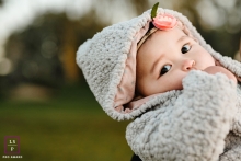 A pro San Jose lifestyle family photo showing a Baby girl outdoors being held A pro San Jose lifestyle family photo showing a Baby girl outdoors being held