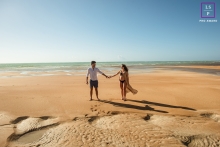 Maceio lifestyle photography of a couple holding hands on the beach in a natural ocean environment