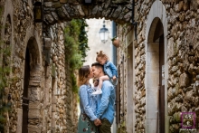 A modern image from Ardeche showing a family of 3 during a lifestyle photography shoot with stone buildings