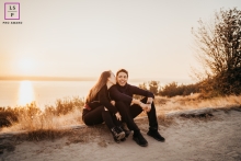 A Sammamish	WA couple showing love for each other and having a fun minute together by the water at sunset