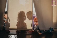 The kids are having a blast together at home in San Diego, their silhouettes illuminated by the sun shining through the window shades