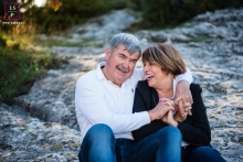 Enchanting Grandparents in Provence: A Heartwarming Portrait of Love and Joy Captured in the picturesque countryside of Provence, France, an endearing lifestyle portrait materializes as a couple of complicit, loving grandparents find solace, radiating joy, on a weathered rock