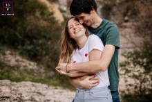 In Ardeche, France, two lovers find joy in each other's company, captured in a lifestyle portrait where laughter intermingles with cuddles