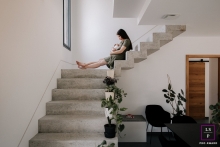 In Drome, France, a mum and her baby find solace at home, as they sit together on the stairs, capturing a beautiful lifestyle portrait