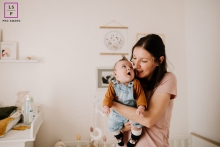 At home in Drome, France, a lifestyle portrait captures the hilariously candid moment as a baby gazes at his mother with a funny expression