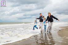 A glimpse of joy and adventure captured by a talented lifestyle photographer in North Holland. A family's beach day turns into a thrilling scene as they get caught by an unexpected wave. 