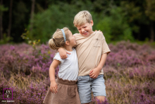 A cheerful portrait of a brother and sister enjoying their time together, smiling amidst the natural beauty of Noord-Holland, The Netherlands.